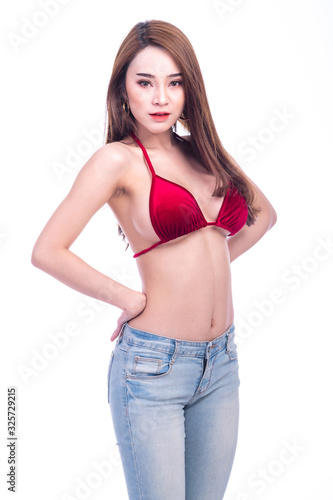 Cute asian woman in red bikini and jeans isolated in white background. Hands on hip. Sexy summer concept.