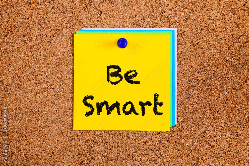 Notes with words Be Smart on corkboard. Notes with words Be Smart on corkboard.