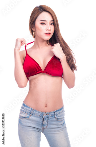 Cute asian woman in red bikini and jeans isolated in white background. Touching bra. Sexy summer concept.