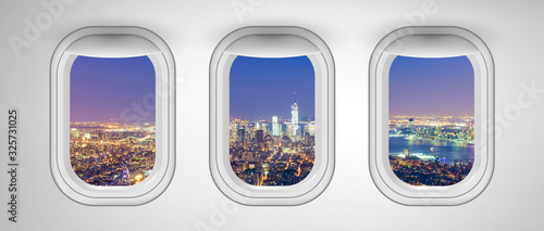 Manhattan night skyline as seen from airplane windows, New York City. Business, travel and holiday concept abstract