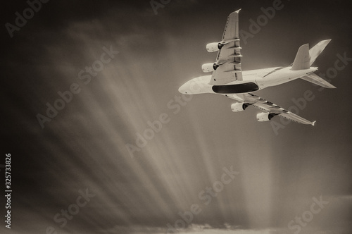 Airplane after take off from the airport, skyward view at sunset photo