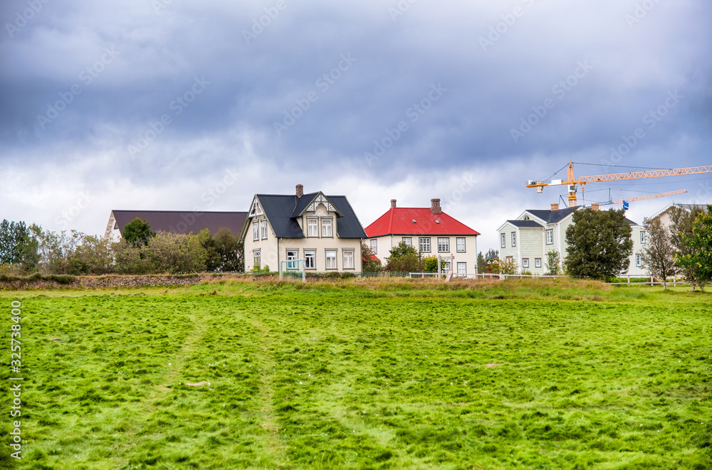 Colourful homes of Iceland with green meadow in summer season