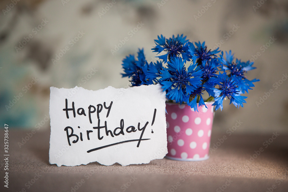 Happy birthday card with greeting words and blue cornflower flowers in ...