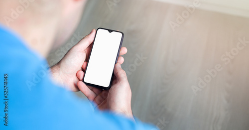 Mockup image of hand holding mobile phone with blank white screen