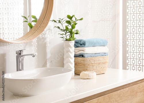 Photos Stylish bathroom interior with mirror and countertop. Design idea