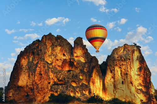 Balloon in the air over fantastic rock formations. The atmosphere of travel and adventure. Turkey, Cappadocia. Goreme.