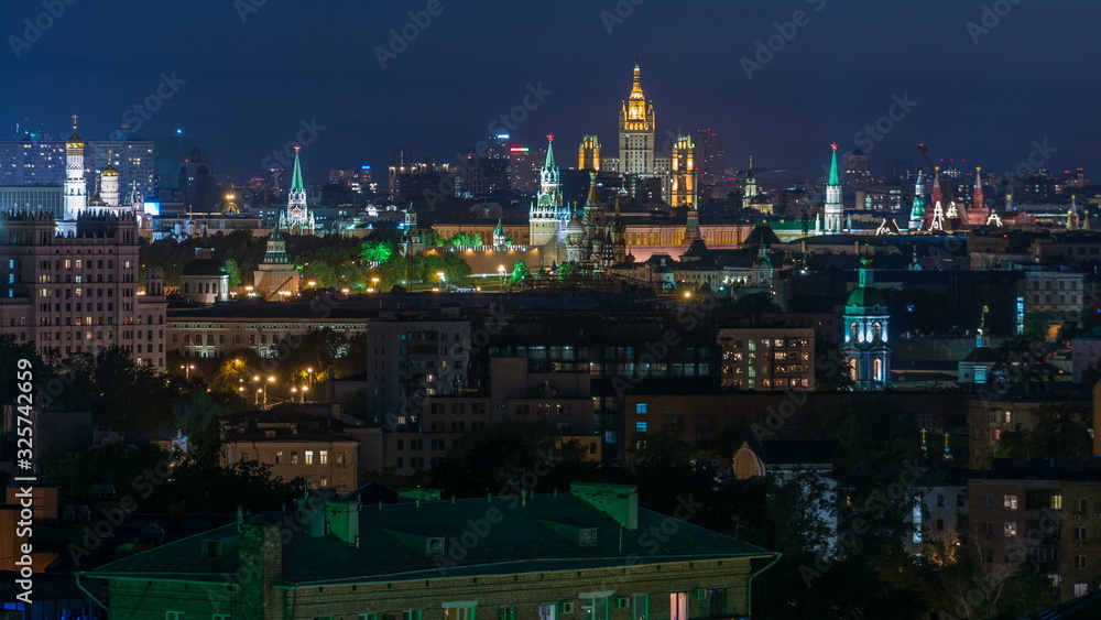 Panoramic view of Moscow timelapse - Kremlin towers, State general store, Stalin skyscraper, residential building at night