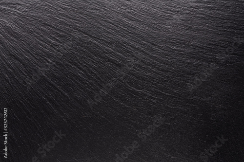 black stone, texture for the background. smooth shadows and light on the structural surface, the concept for the design