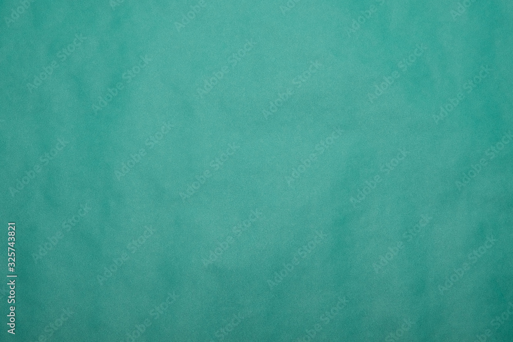 Background from green paper. Crumpled paper texture. Background, texture of colored parchment paper. Background from green paper. Crumpled paper texture. Background, texture of colored parchment paper.