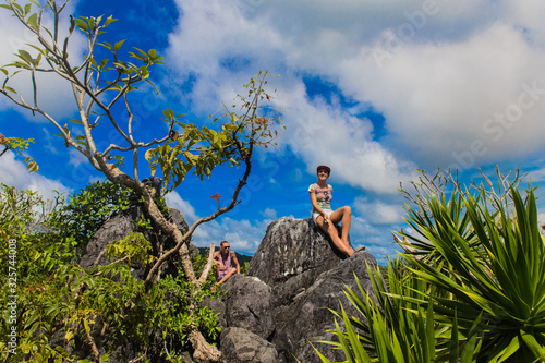 girl sitting in the top of ille cave with green valley in El Nido, Palawan province, Philippines photo