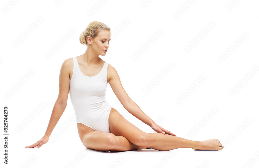 Young, beautiful, slim and healthy blond girl in white swimsuit applying skincare cream. Massage, skincare, healthcare, wrinkles removal and fitness. Young, beautiful, slim and healthy blond girl in white swimsuit applying skincare cream. Massage, skincare, healthcare, wrinkles removal and fitness.