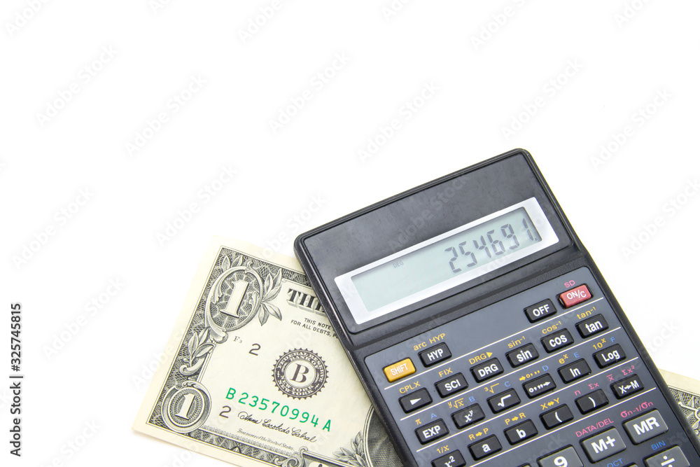 A black engineering calculator (not completely, but part) with gray buttons and a banknote of one American dollar under it. White isolated background. Accounting for finance and budget. A black engineering calculator (not completely, but part) with gray buttons and a banknote of one American dollar under it. White isolated background. Accounting for finance and budget.