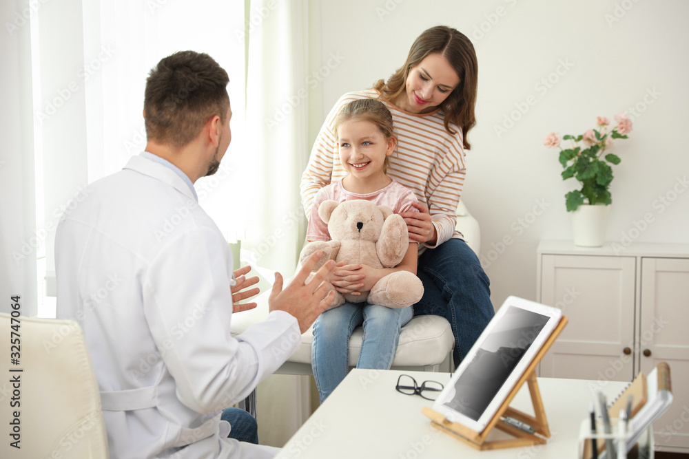 Mother and daughter visiting pediatrician. Doctor working with patient in hospital Mother and daughter visiting pediatrician. Doctor working with patient in hospital