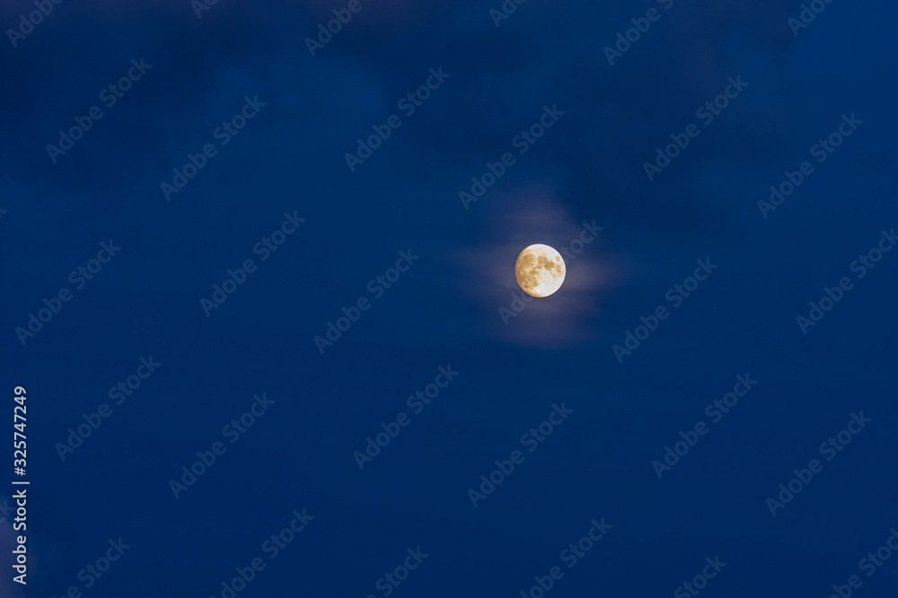 A beautiful moon with details on a blue evening sky, Romania