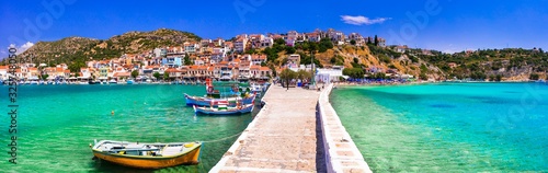 Traditional colorful Greece - travel in beautiful Samos Island, scenic Pythagoion town. view with traditional boats photo