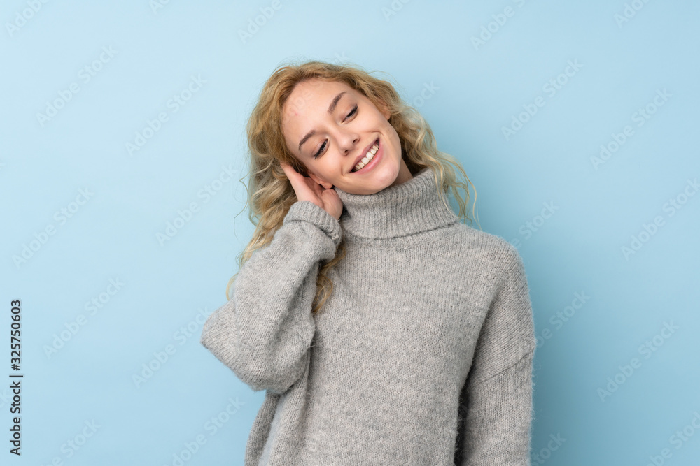 Young blonde woman wearing a sweater isolated on blue background thinking an idea Young blonde woman wearing a sweater isolated on blue background thinking an idea