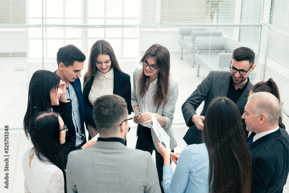boss and a group of employees discussing business documents. boss and a group of employees discussing business documents.