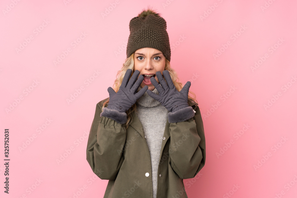 Young girl with winter hat isolated on pink background with surprise facial expression Young girl with winter hat isolated on pink background with surprise facial expression