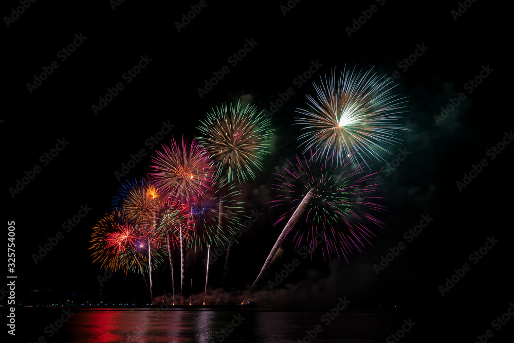 Colorful fireworks of various colors at night with celebration and anniversary concept
