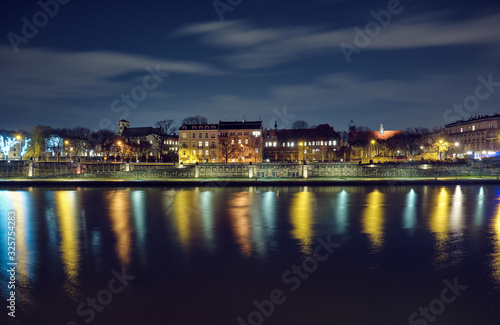 Night cityscape in Krakow at night. © badahos