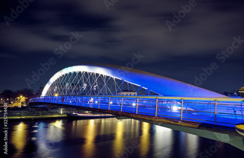 Father Bernatek's Bridge in Krakow at night.