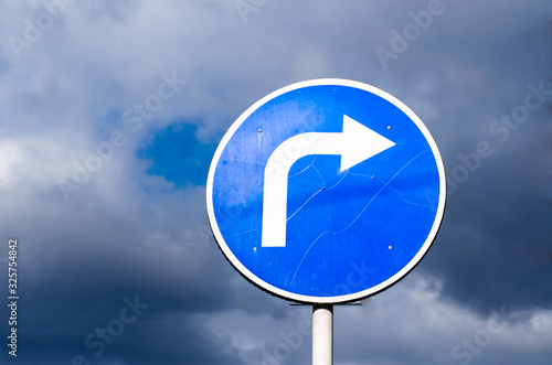 Turn right road sign on sky background with clouds © Шатыров Александр