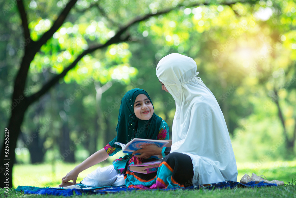 Muslim Mother Talking About Islam With Adorable Muslim Girl In Hijab At Green Park Concept
