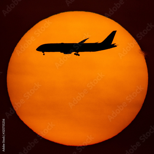 Silhouette of passenger airplane with the morning sunrise background