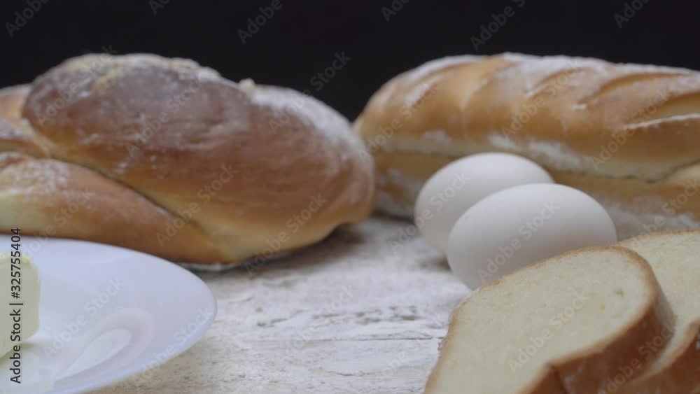 Female hand takes a glass of milk, on the background of bakery products, butter, egg,. breakfast. dairy. Female hand takes a glass of milk, on the background of bakery products, butter, egg,. breakfast. dairy.