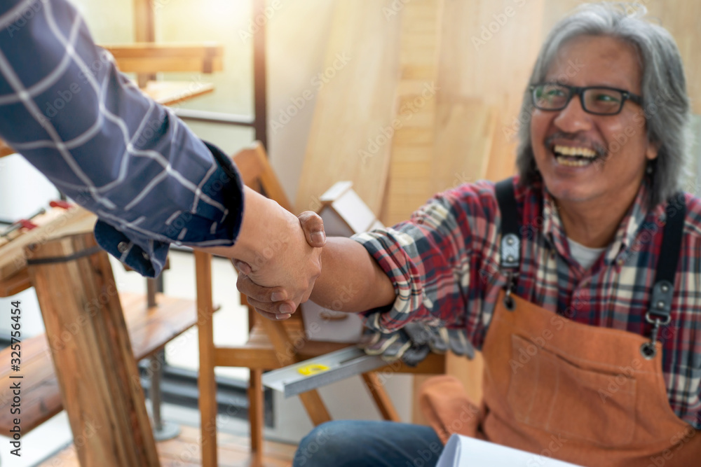 Crafts man shaking hands with his friend when finish work, Craftsman concept