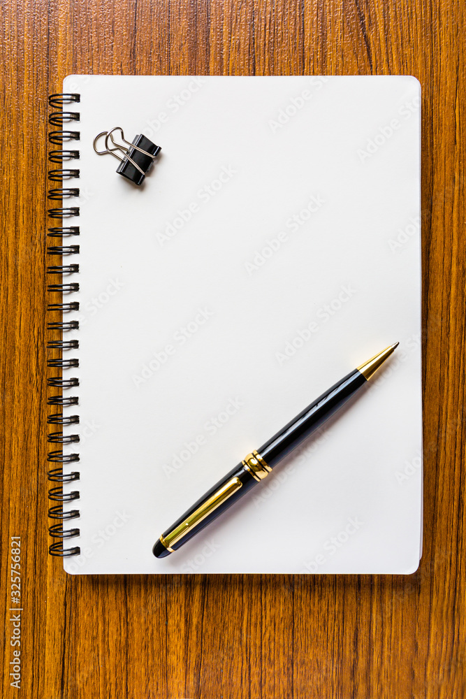 close up opening note paper and pen on wood texture background with copy space close up opening note paper and pen on wood texture background with copy space