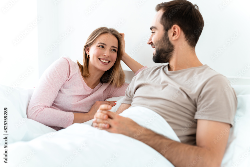 Portrait of young happy couple smiling and looking at each other Portrait of young happy couple smiling and looking at each other