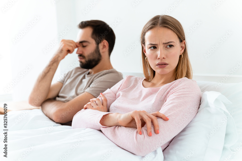 Portrait of caucasian resentful couple lying at bedroom after argument Portrait of caucasian resentful couple lying at bedroom after argument
