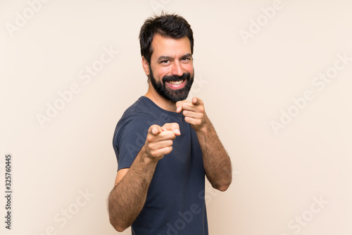 Man with beard points finger at you with a confident expression