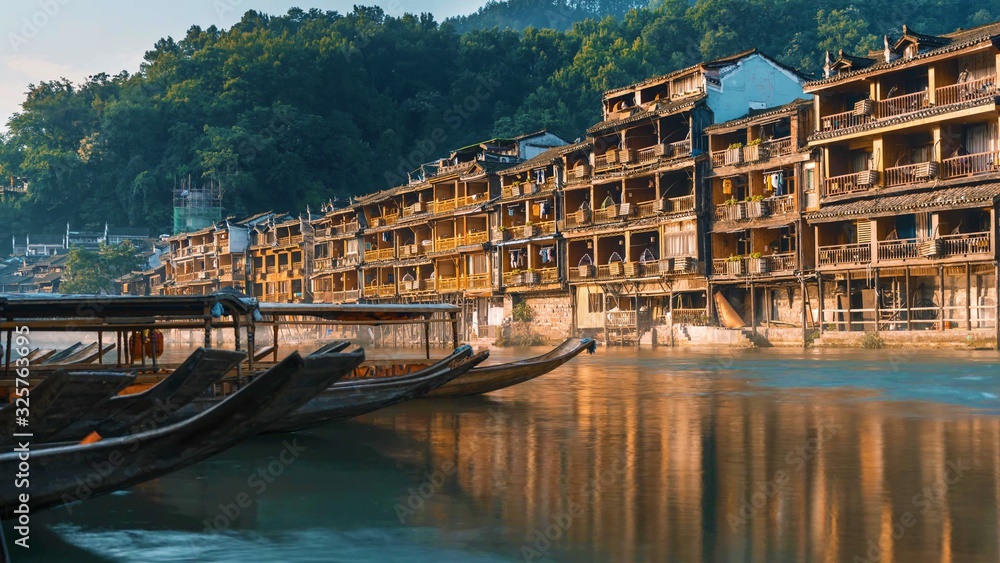 Buildings and boats by the river in Fenghuang County. Hunan, China