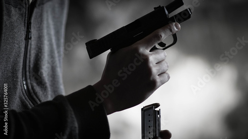 Man loading a small 9mm pistol. Personal defense and concealed carry concept