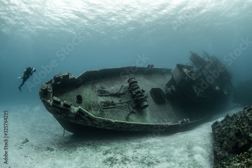 Obraz na plátně Divers examining the famous USS Kittiwake submarine wreck in the Grand Cayman Is
