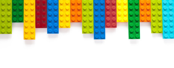 Colored toy bricks on white background