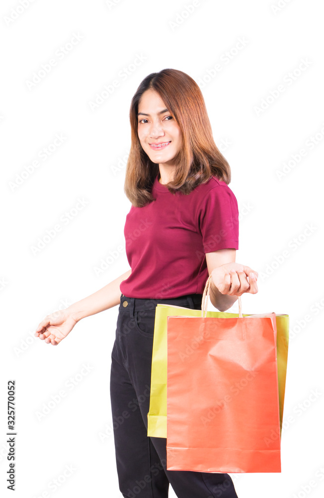 young woman pretty smiling holding paper bags green and orange shopping. on white background and looking at camera young woman pretty smiling holding paper bags green and orange shopping. on white background and looking at camera