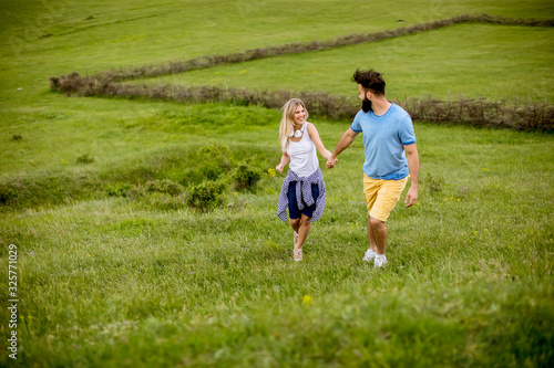 Loving couple enjoying a walk through grass land