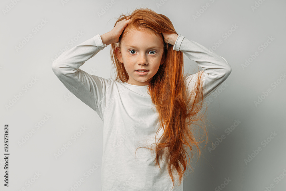 Naklejka premium attractive caucasian girl with long red hair isolated over white background. adorable, sweet girl with natural red hair look at camera and smile. people diversity, bewitching beauty concept
