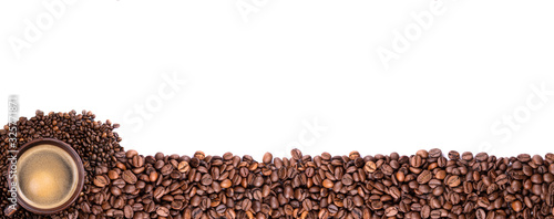 Fototapeta Naklejka Na Ścianę i Meble -  a Cup of coffee and coffee beans on an isolated background close up view from the top