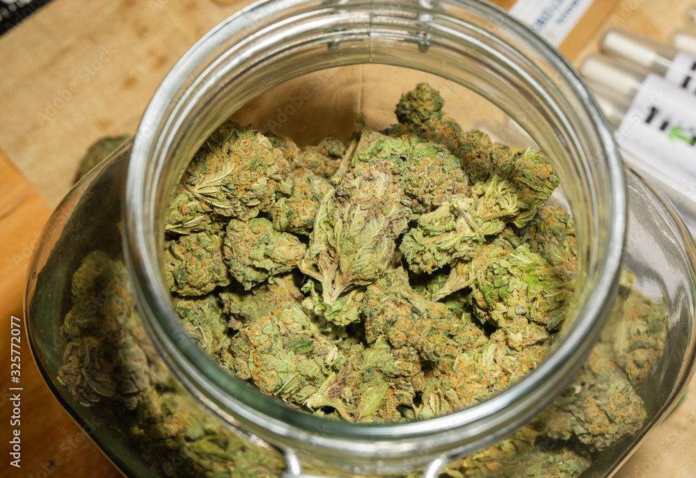 Close up detail of cannabis buds (ob reaper strain) on glass jar Close up detail of cannabis buds (ob reaper strain) on glass jar