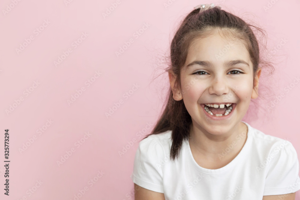 Portrait of happy laughing child girl on pastel background. Smiling kid. Positive emotions. Portrait of happy laughing child girl on pastel background. Smiling kid. Positive emotions.