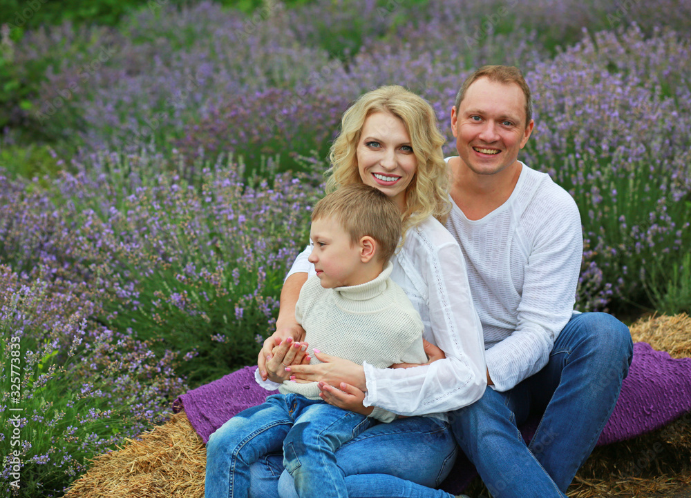 happy family with boy relax in lavender field in summer happy family with boy relax in lavender field in summer