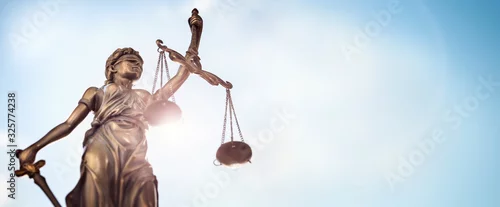 Fototapeta samoprzylepna Legal law concept statue of Lady Justice with scales of justice sky background