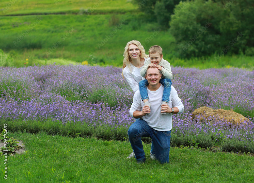 Fototapeta premium happy family with boy relax in lavender field in summer