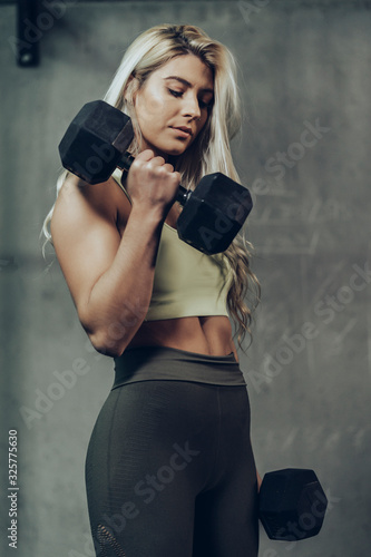 Side view of young blonde sportswoman exercising her arms. © Mikel Taboada