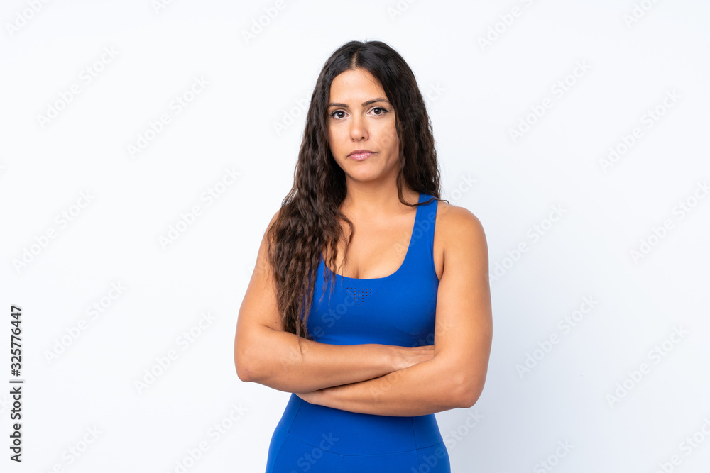 Young sport woman over isolated white background with arms crossed Young sport woman over isolated white background with arms crossed