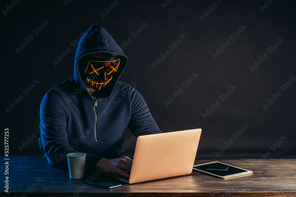 hacker man sit with laptop try to get password or to enter computer system, computer genius engaged in crime. man use computer knowledge in order to access illegally in system and networks of others hacker man sit with laptop try to get password or to enter computer system, computer genius engaged in crime. man use computer knowledge in order to access illegally in system and networks of others